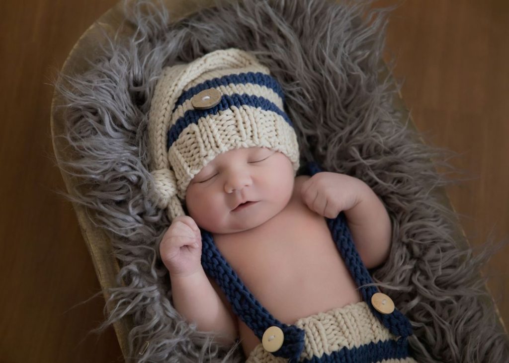 newborn baby sleeping in basket